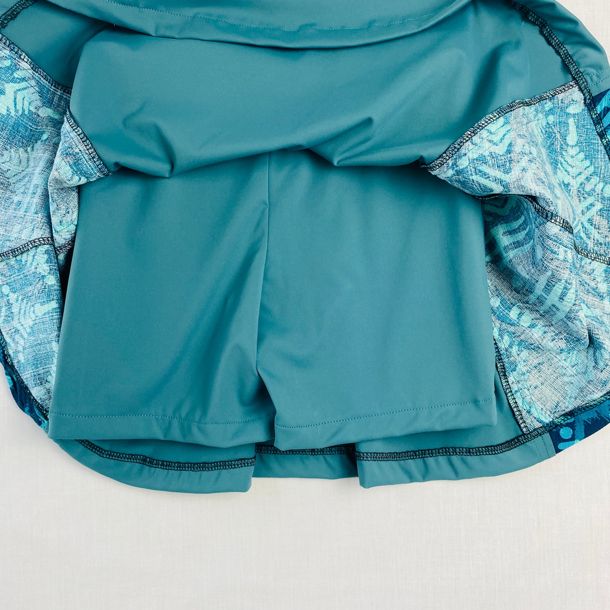 Teal girls’ sports skort with a darker blue patterned side panel. Made from soft nylon, spandex, and cotton blend with built-in shorts for comfort and coverage.

Designed for movement, comfort, and everyday active wear.

Perfect for pickleball, tennis, dance, school sports, and casual outings.

Proudly designed and made in Australia.